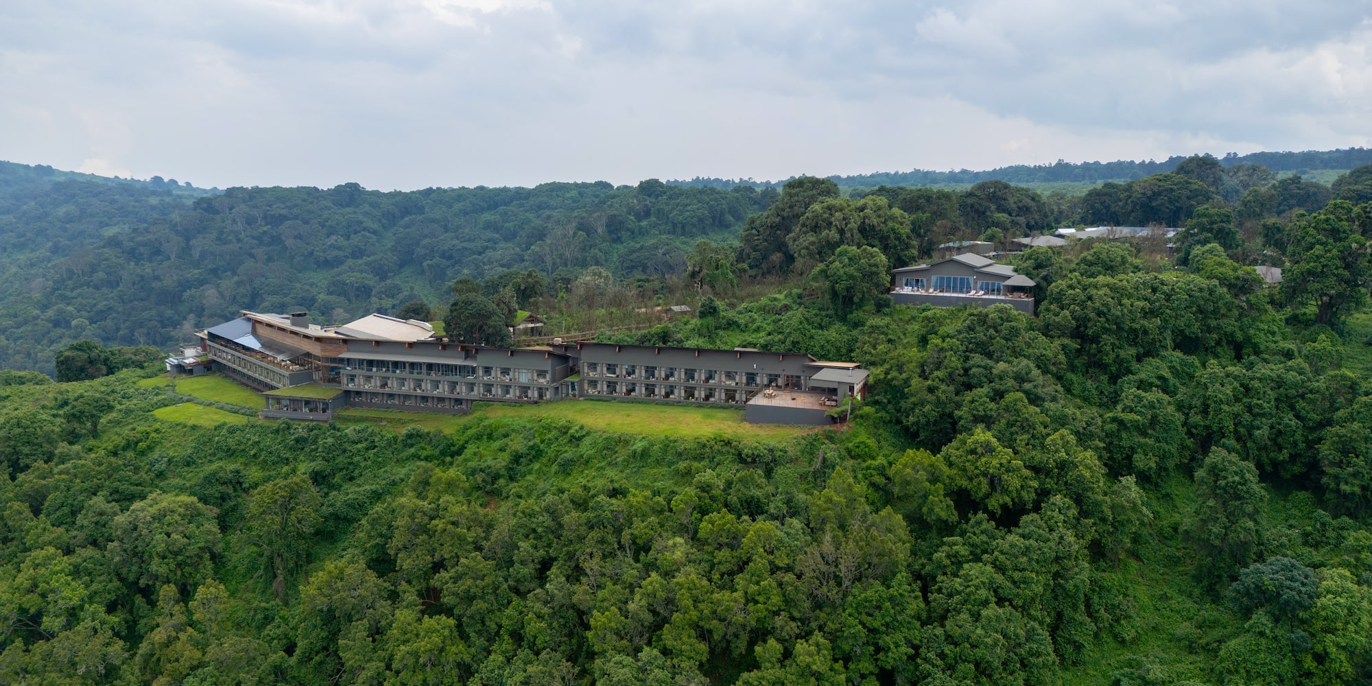 a building on a hill with trees
