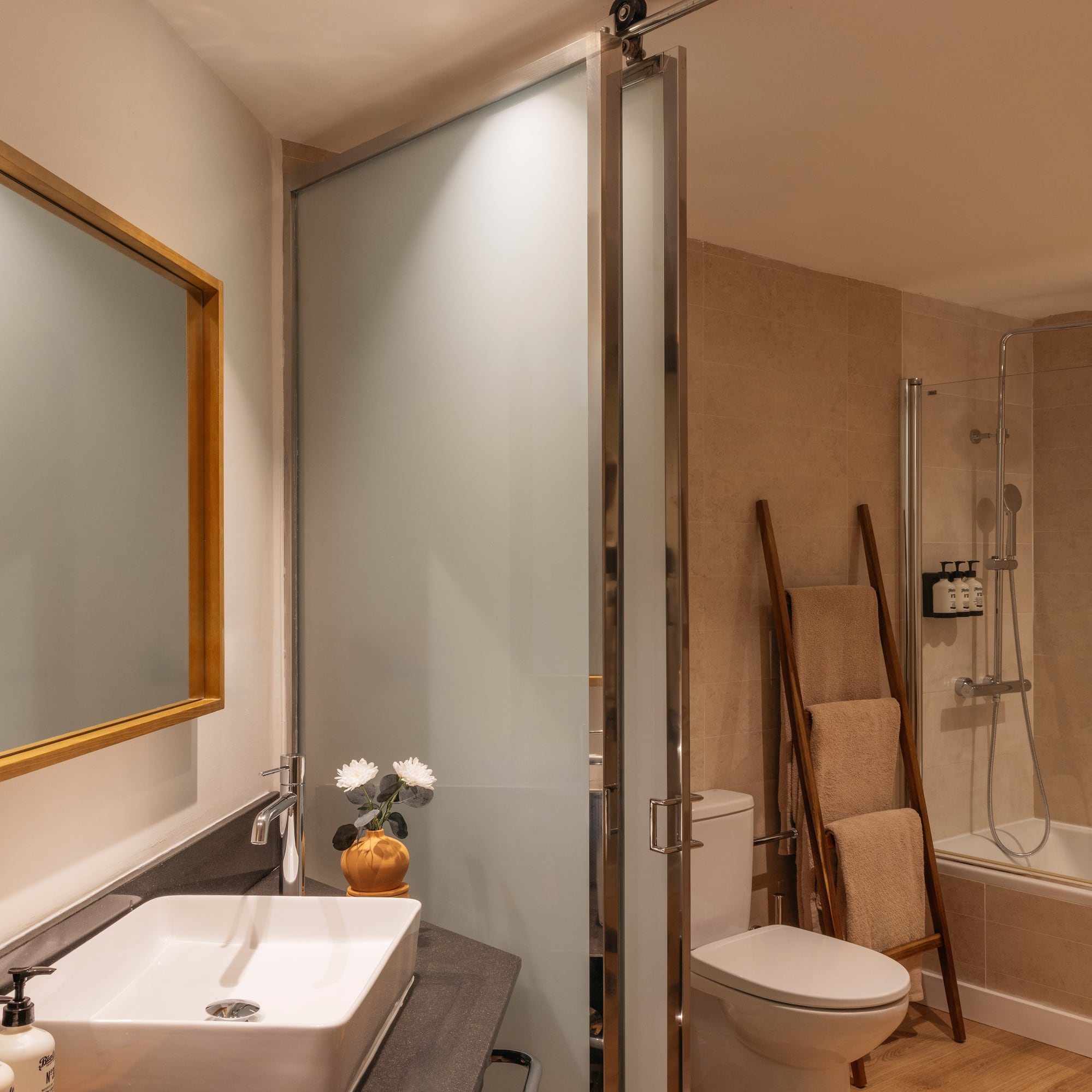 a bathroom with a sink toilet and shower