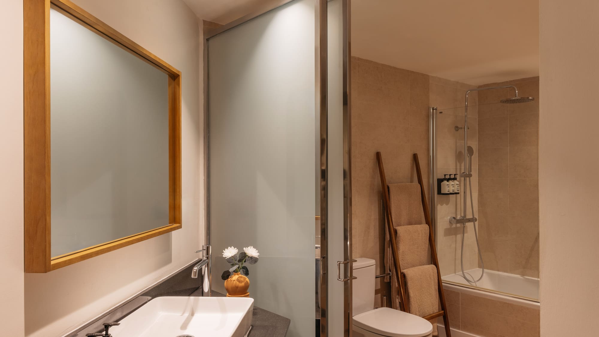 a bathroom with a sink toilet and shower