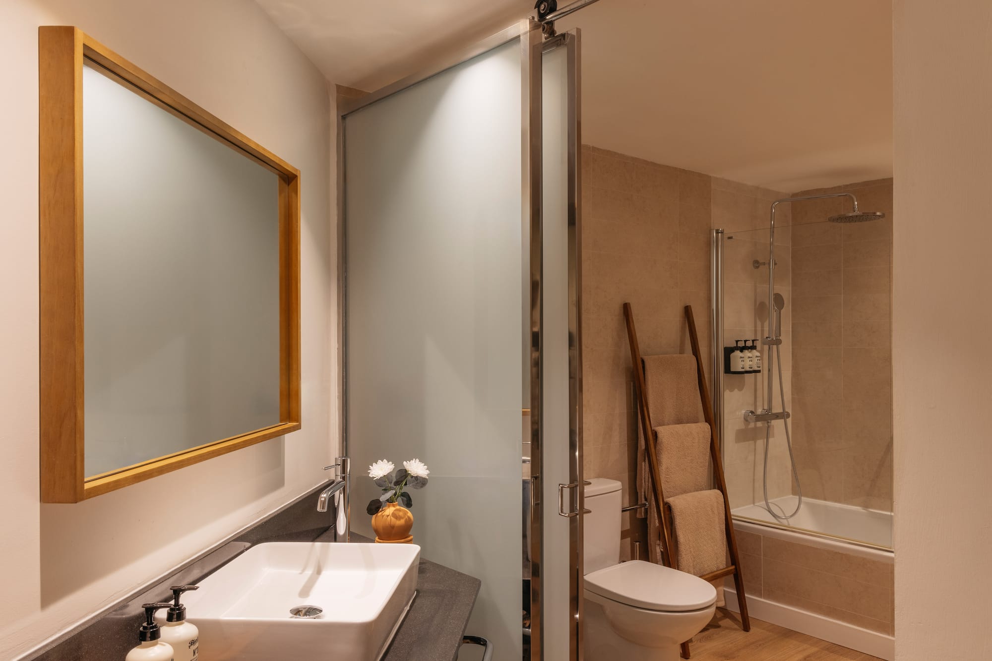 a bathroom with a sink toilet and shower