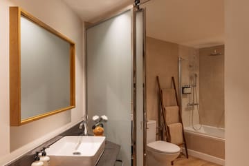 a bathroom with a sink toilet and shower