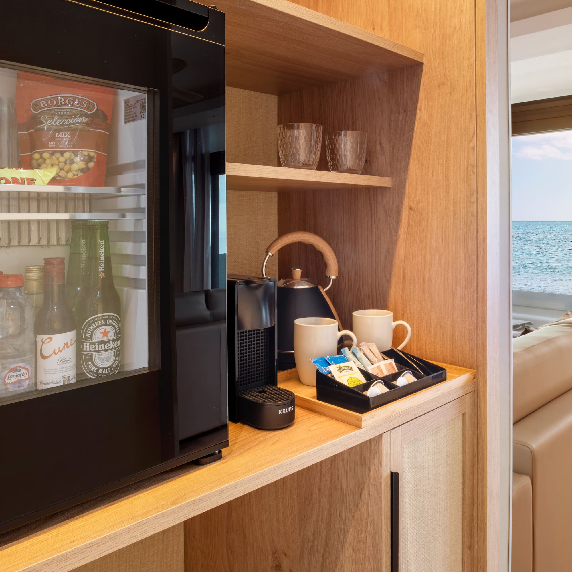 a refrigerator and coffee cups on a shelf