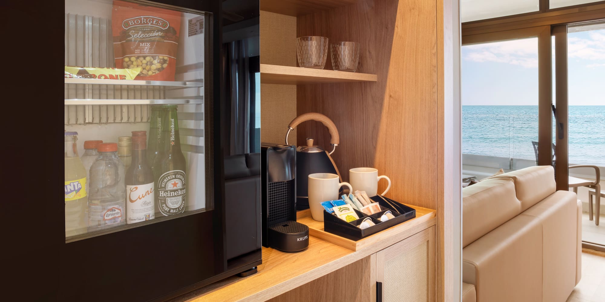 a refrigerator and coffee cups on a shelf