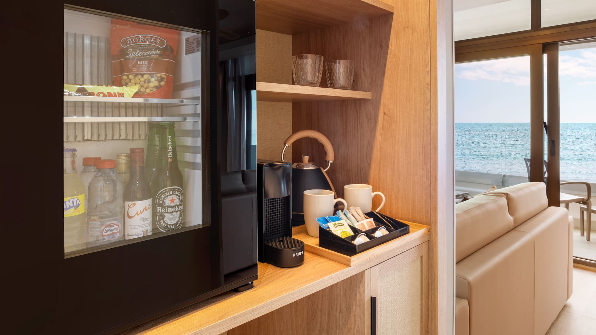 a refrigerator and coffee cups on a shelf