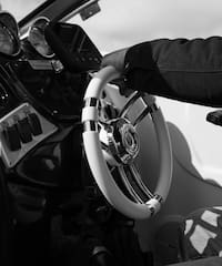 a hand holding a steering wheel