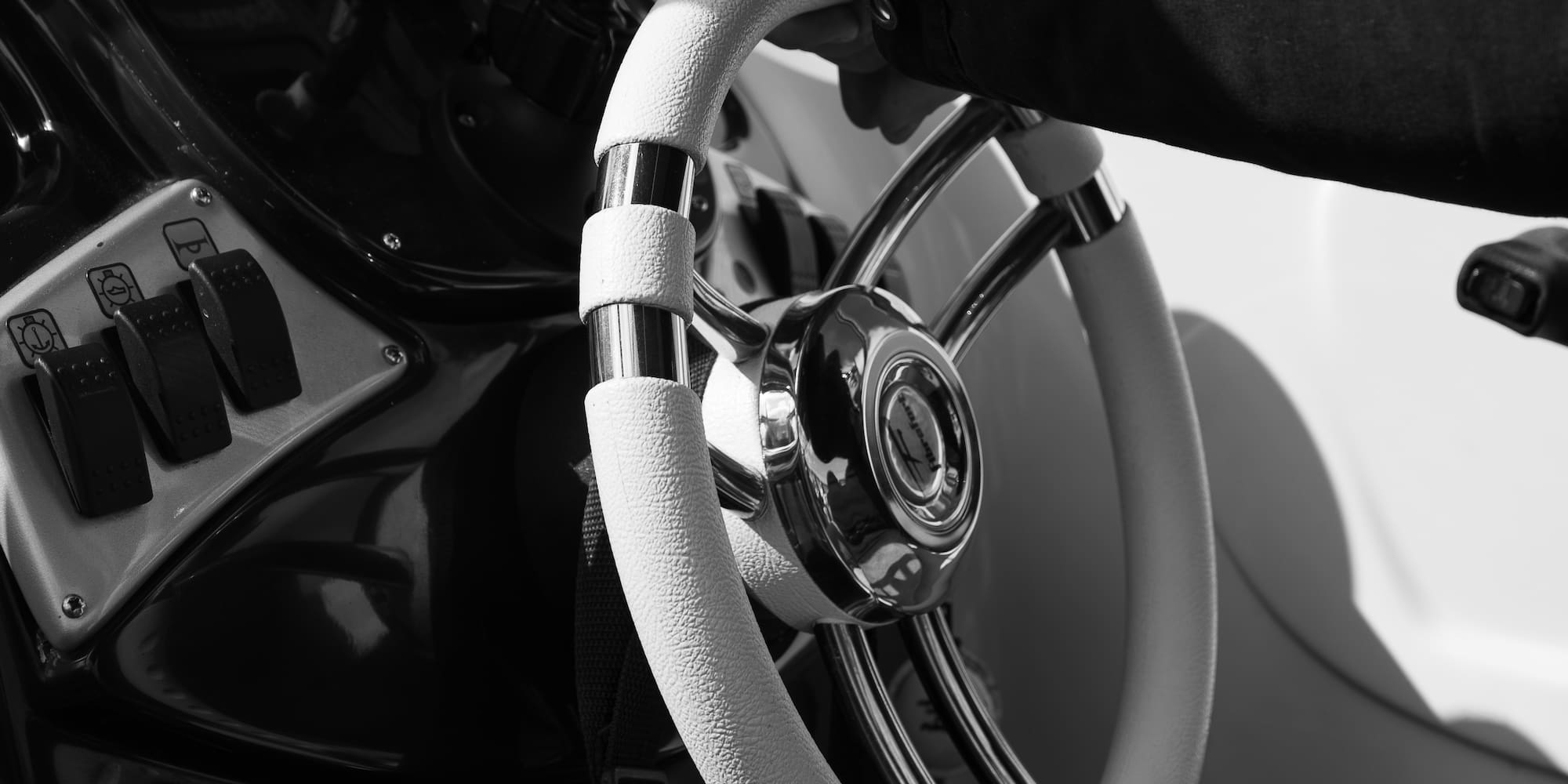 a hand holding a steering wheel