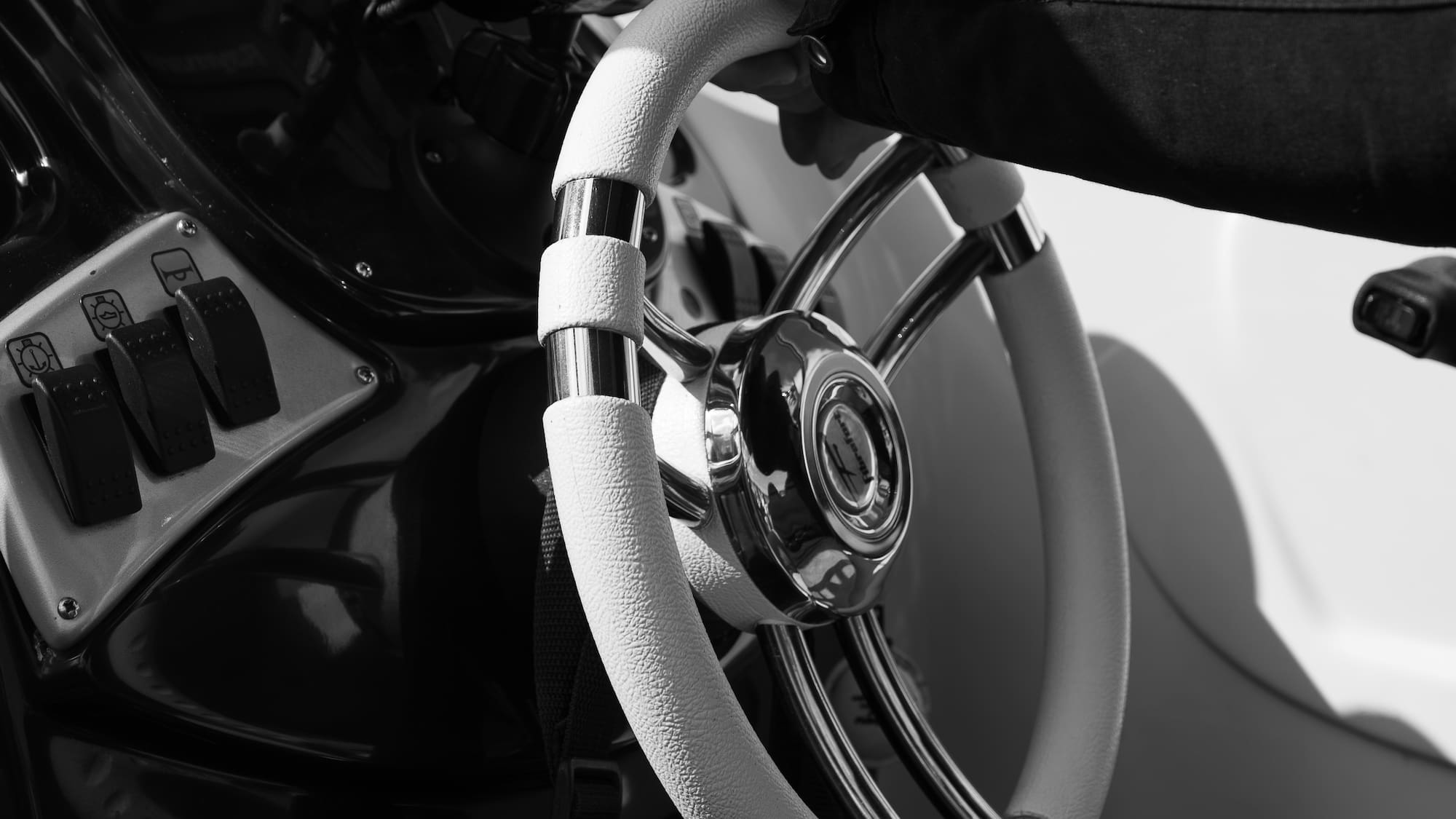a hand holding a steering wheel