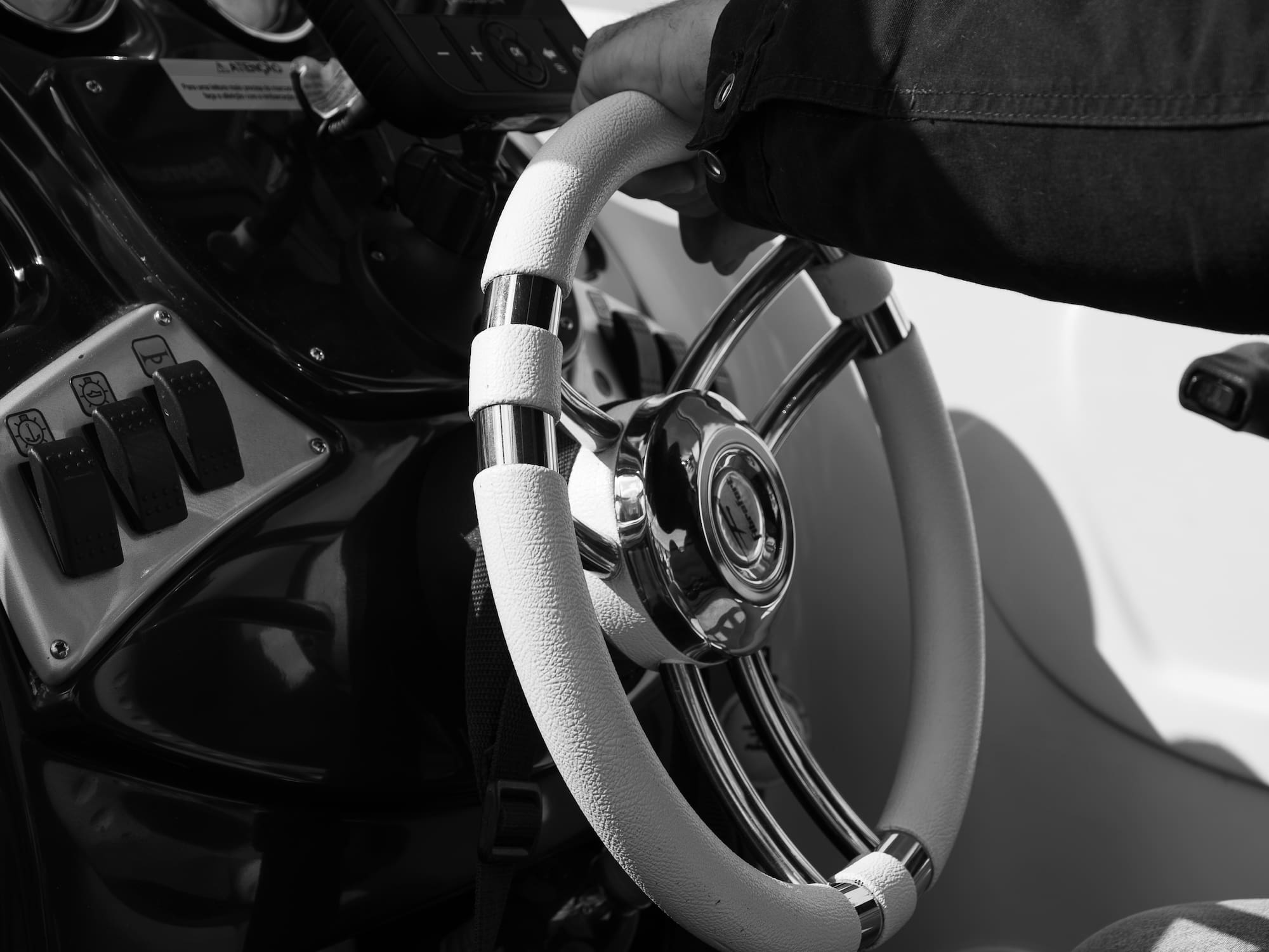 a hand holding a steering wheel