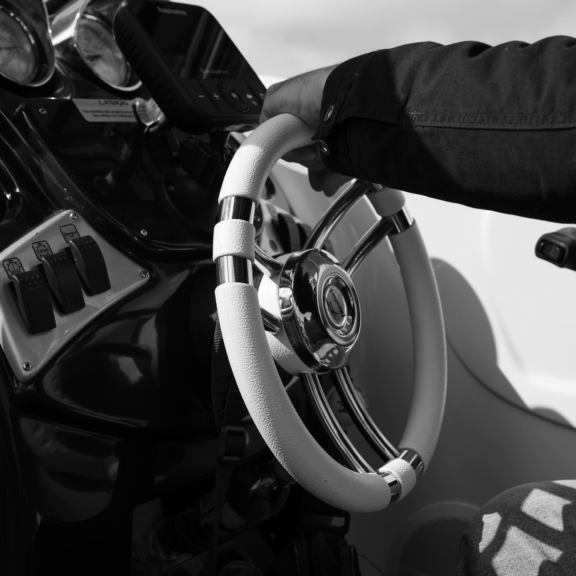 a hand holding a steering wheel