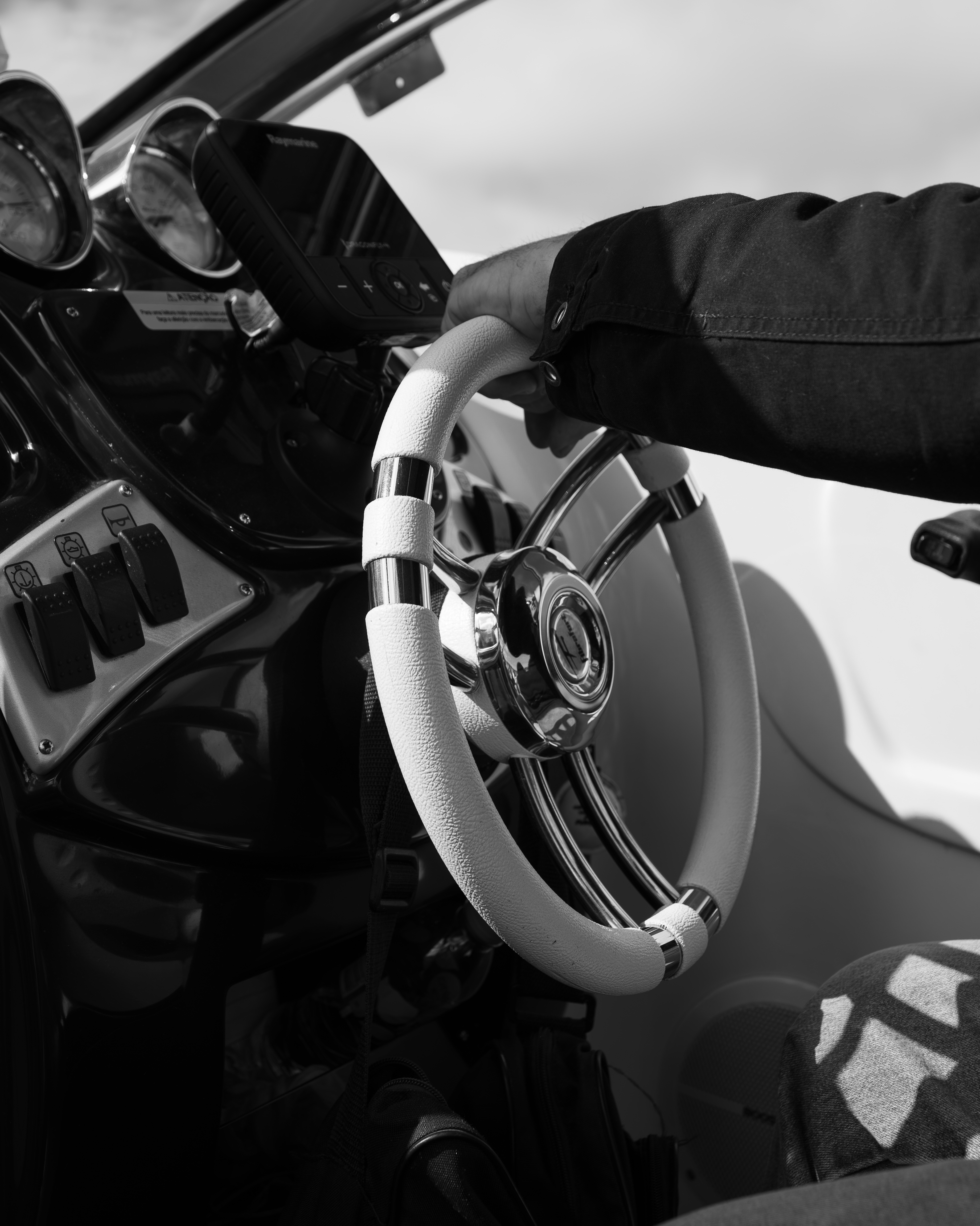 a hand holding a steering wheel