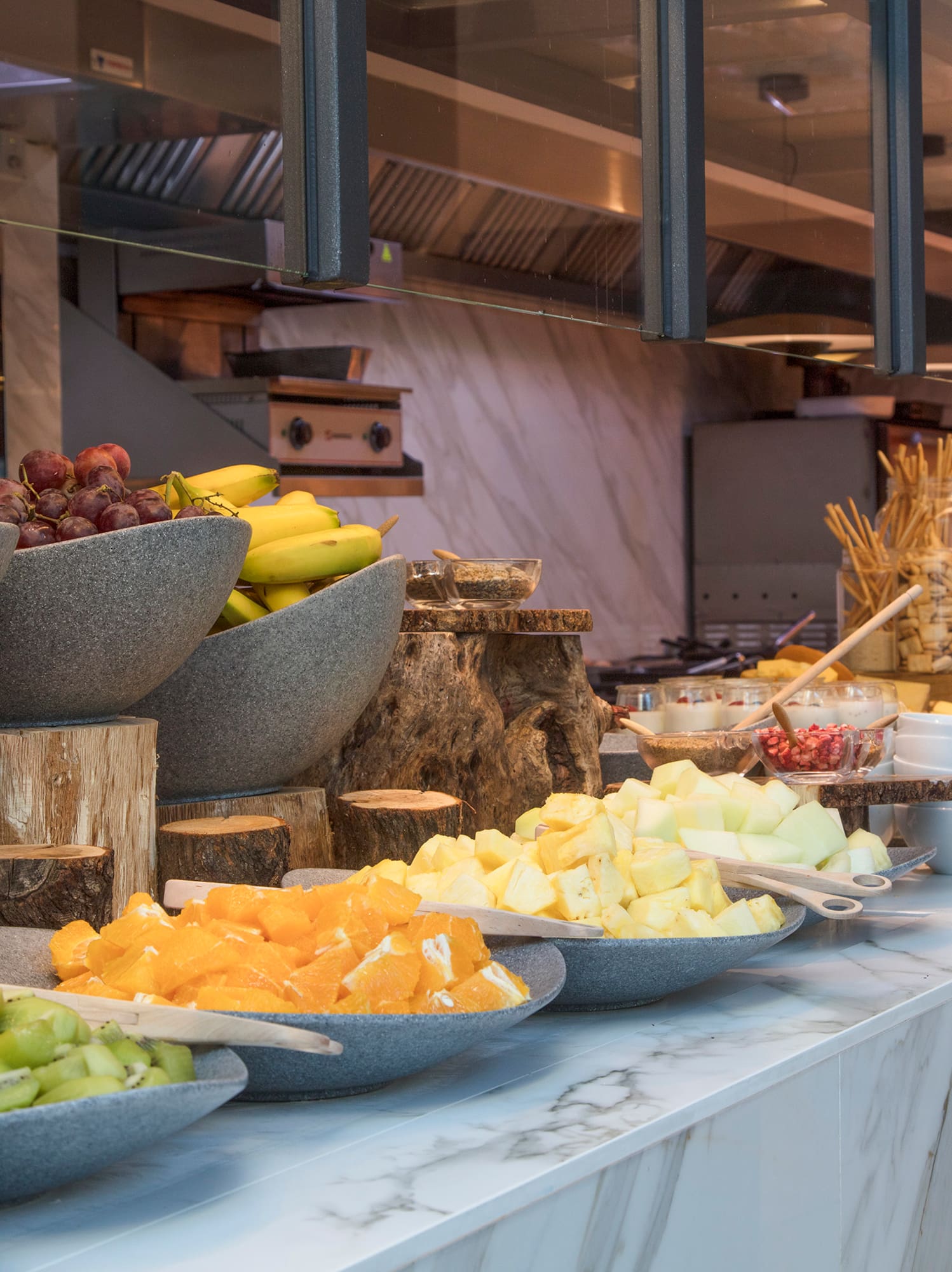 a counter with bowls of fruit