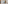 Bright hotel bedroom with sea view balcony, white bed, and wooden decor.