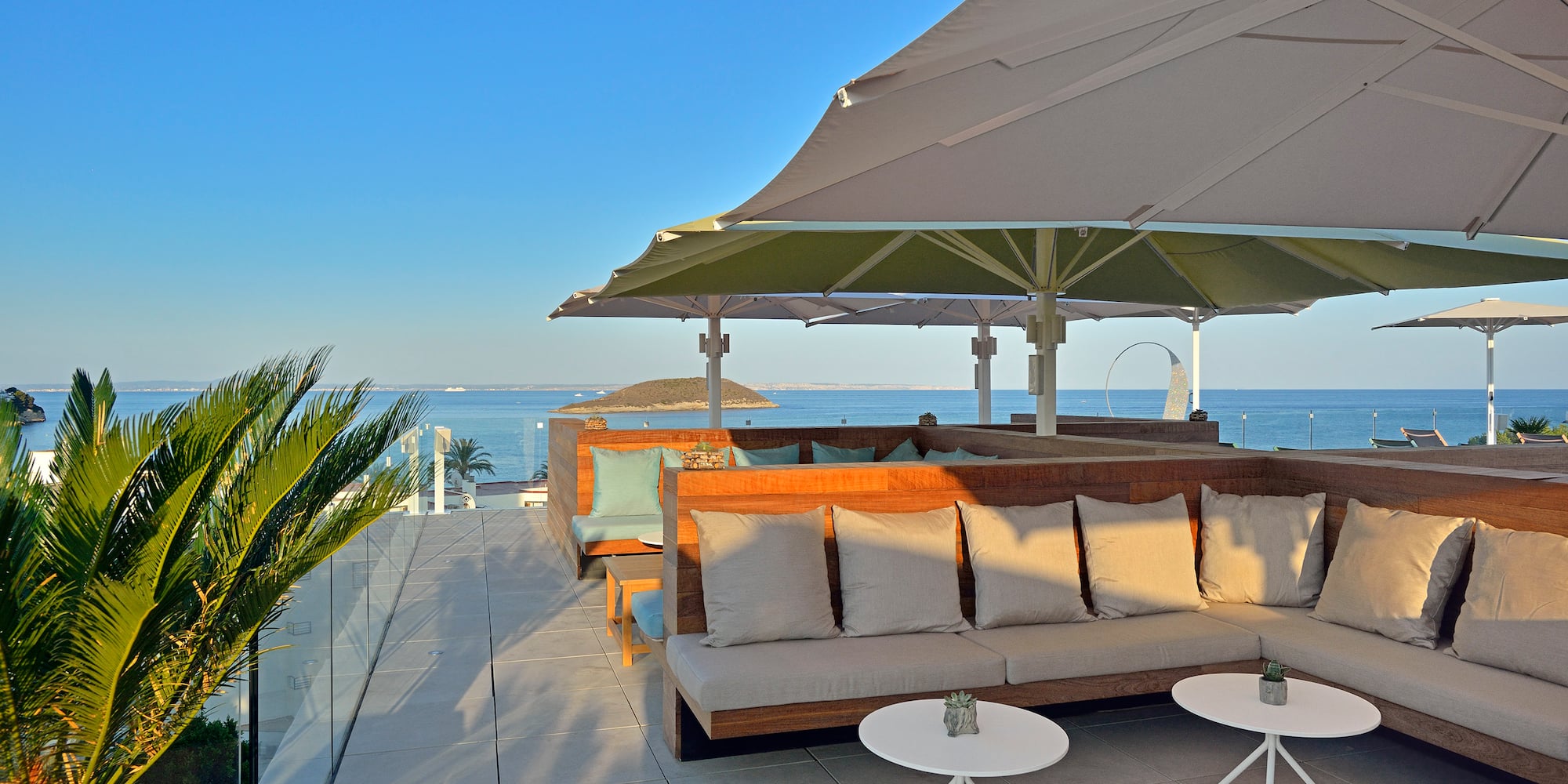 a patio with a couch and umbrella