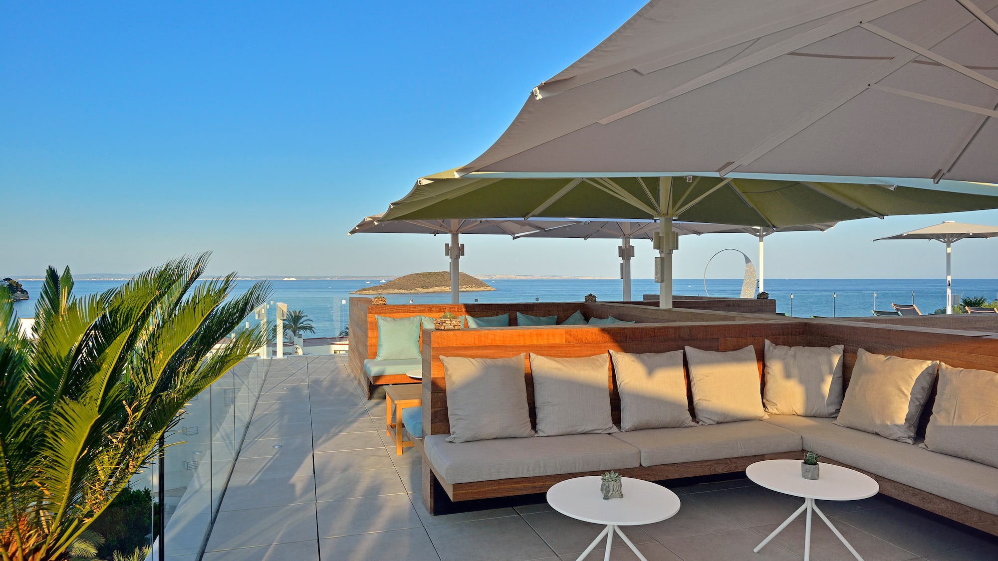 a patio with a couch and umbrella