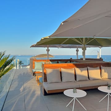 a patio with a couch and umbrella