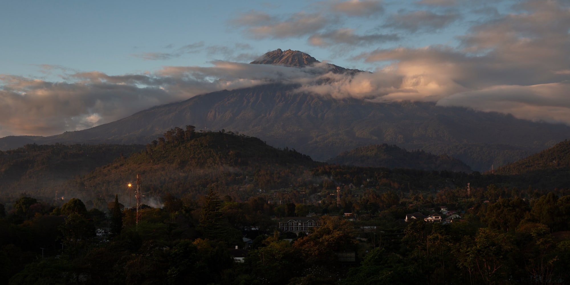 a mountain with clouds in the sky