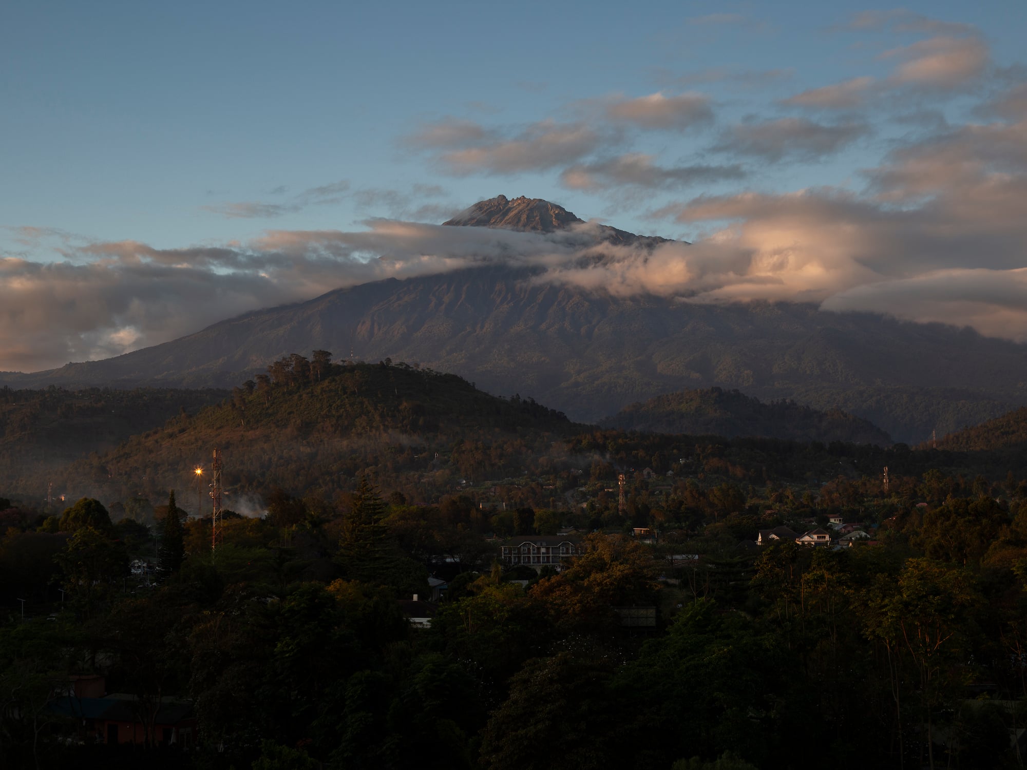a mountain with clouds in the sky