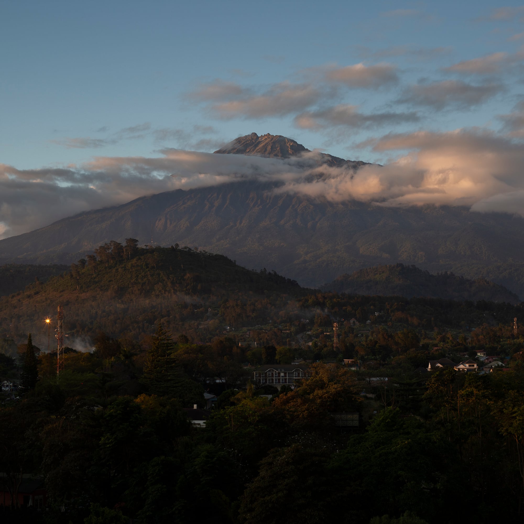 a mountain with clouds in the sky