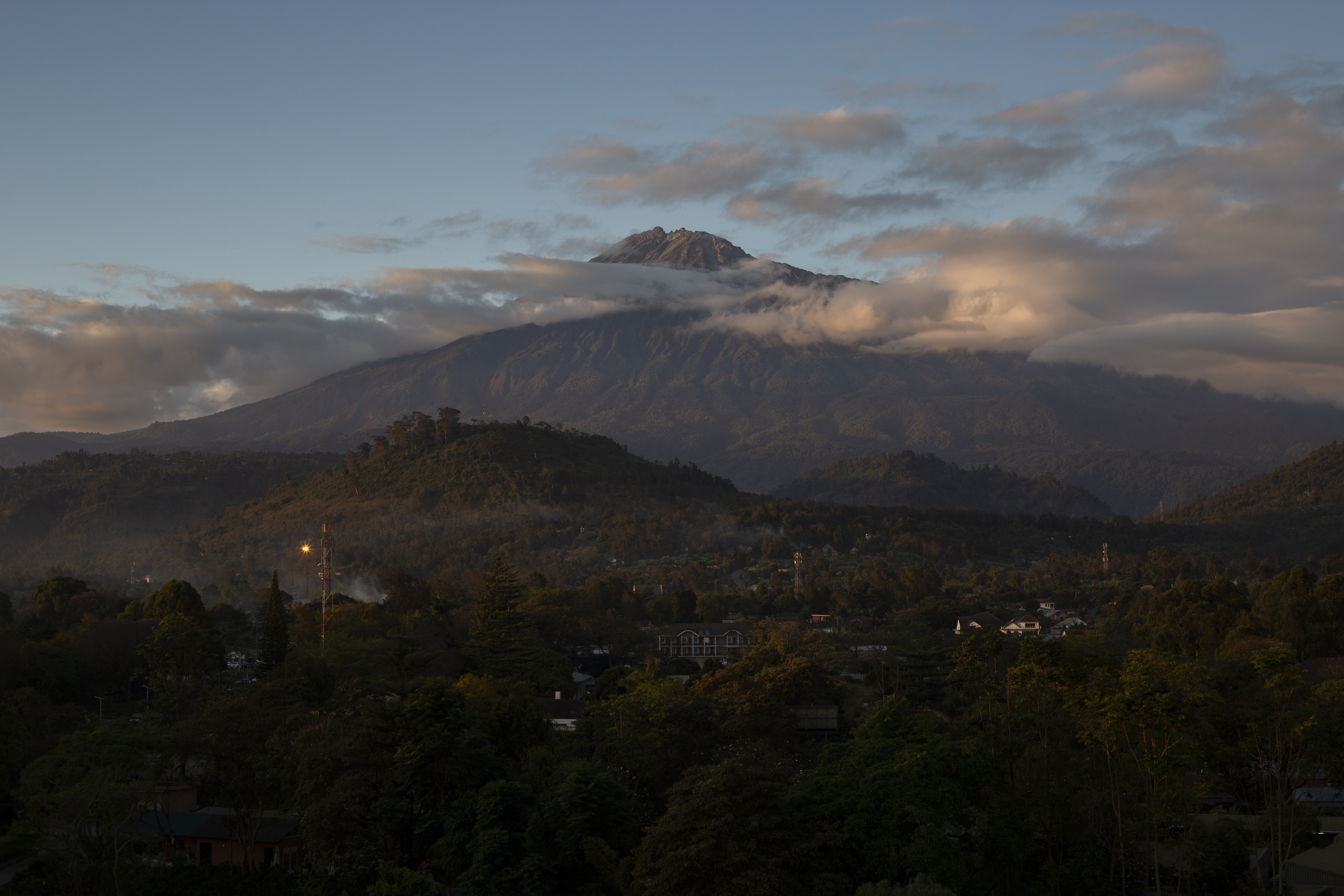 a mountain with clouds in the sky