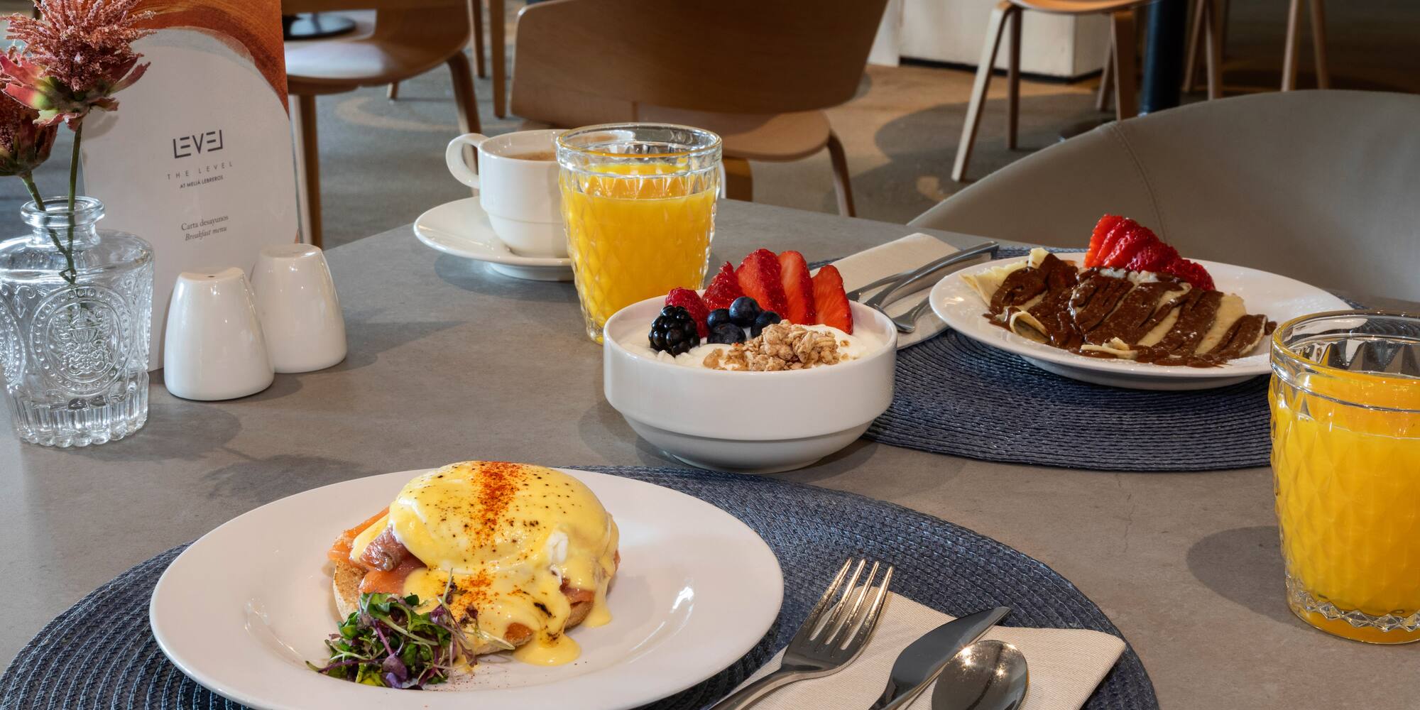 a table with plates of food and drinks