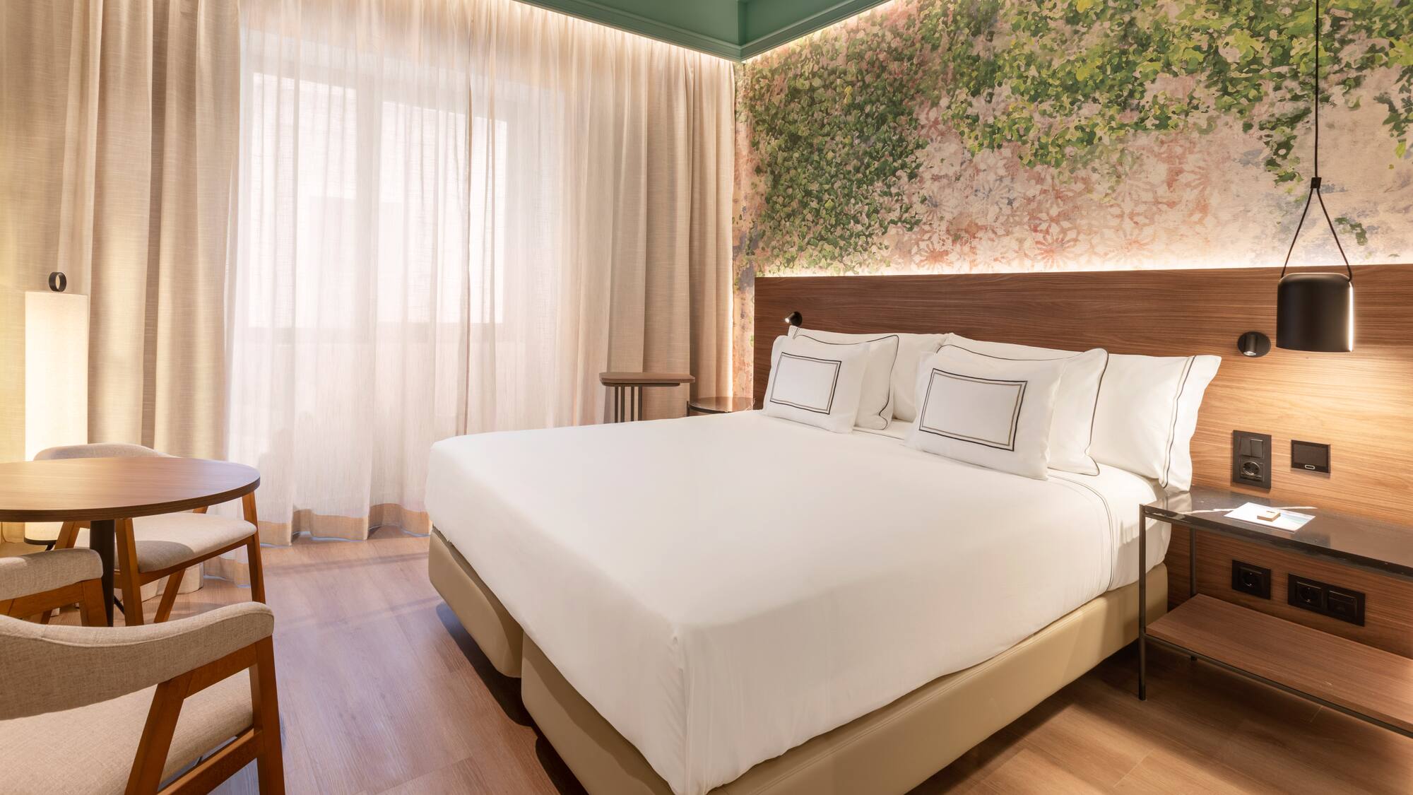 a bed with white sheets and a wood floor