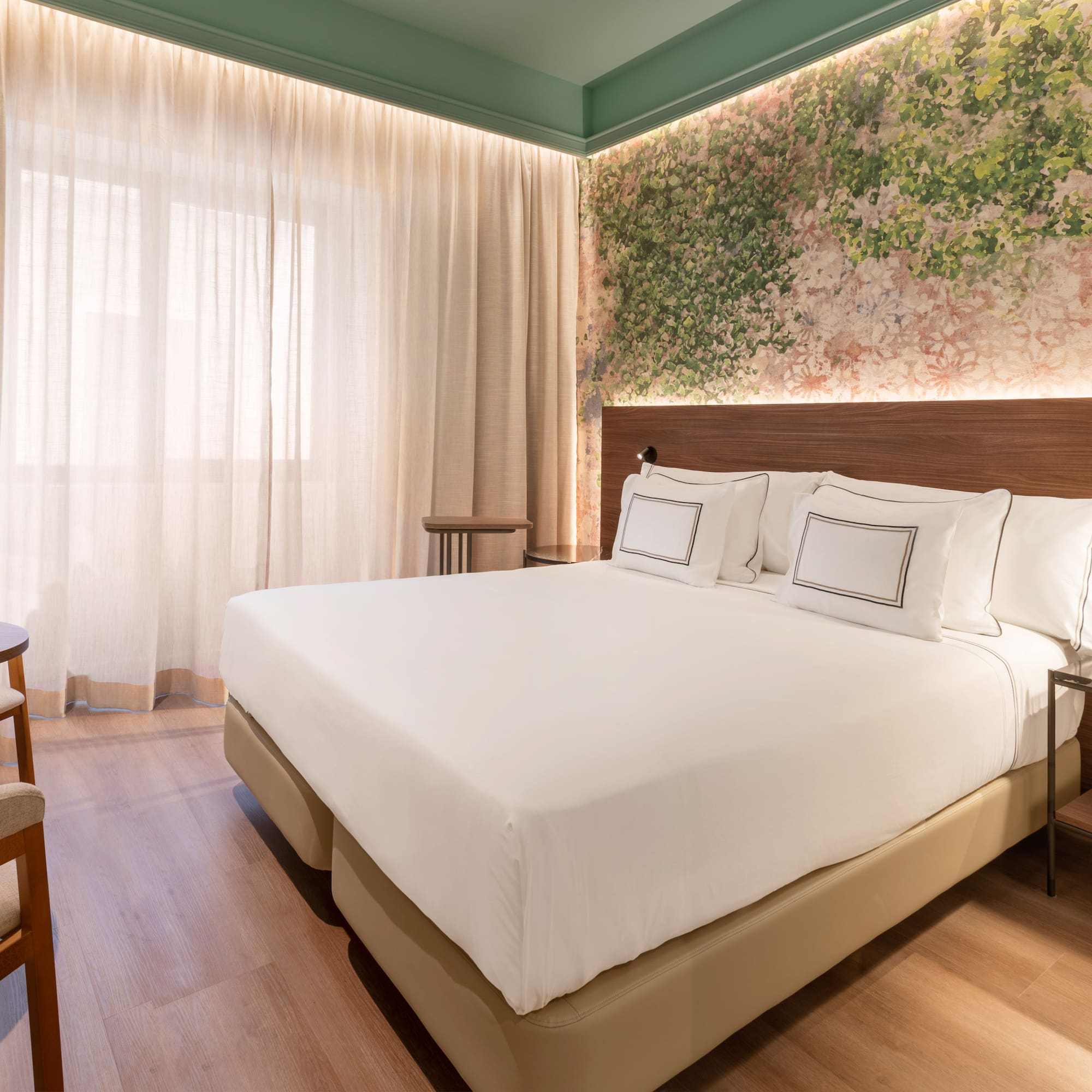 a bed with white sheets and a wood floor