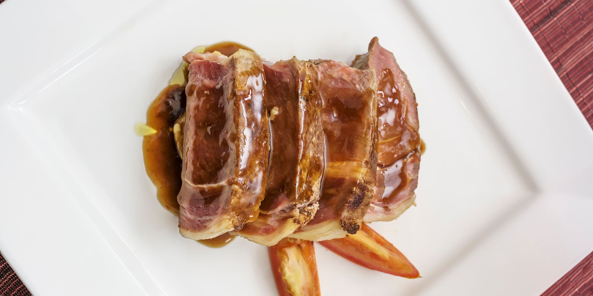 a plate of meat and sauce