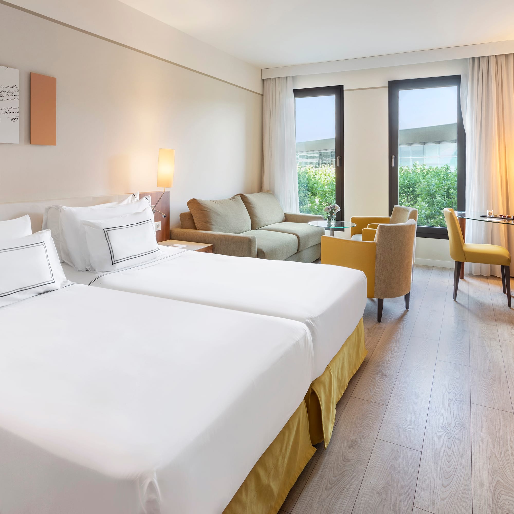 a room with two beds and a table