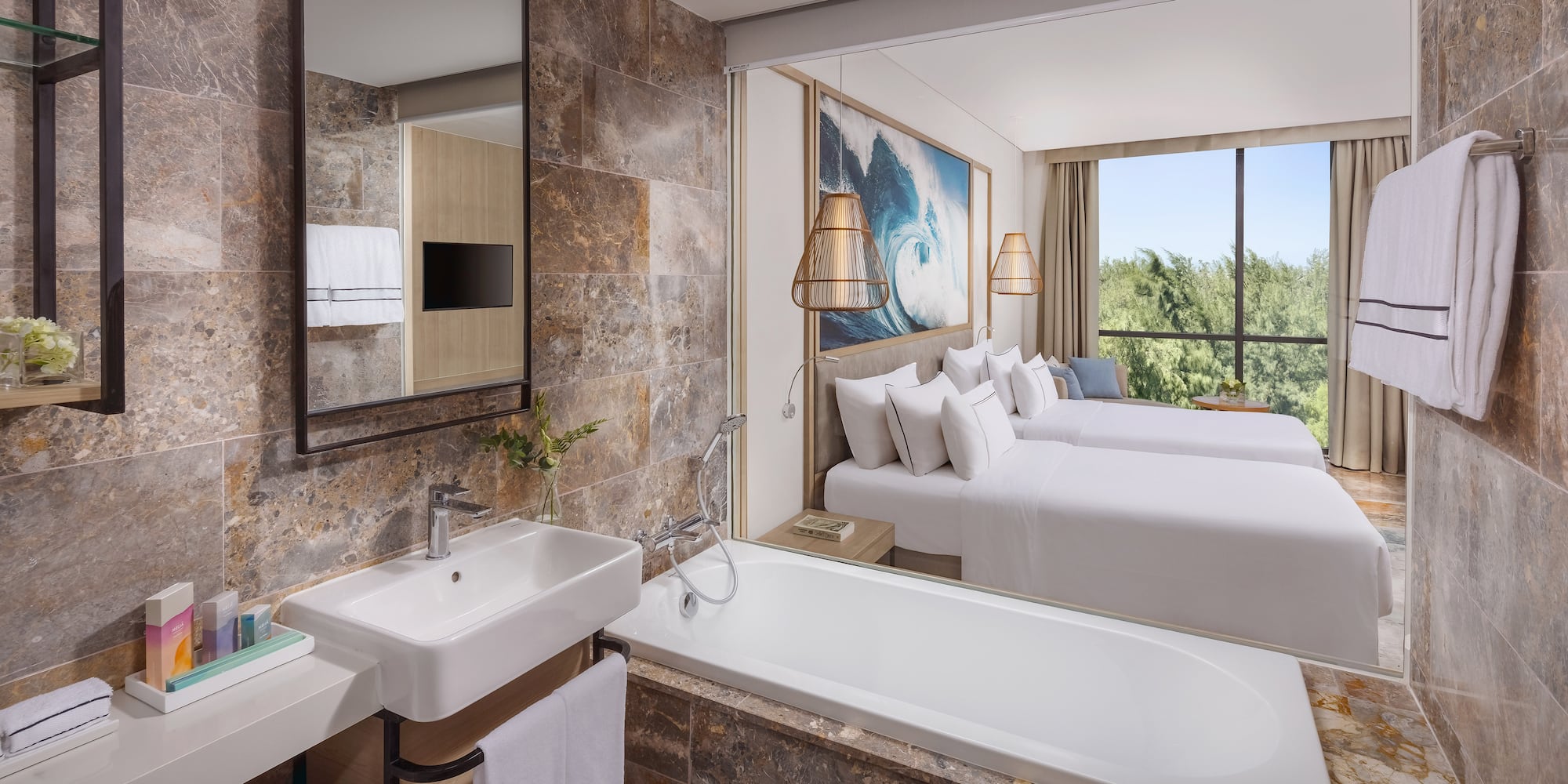 a bathroom with a bathtub and two beds