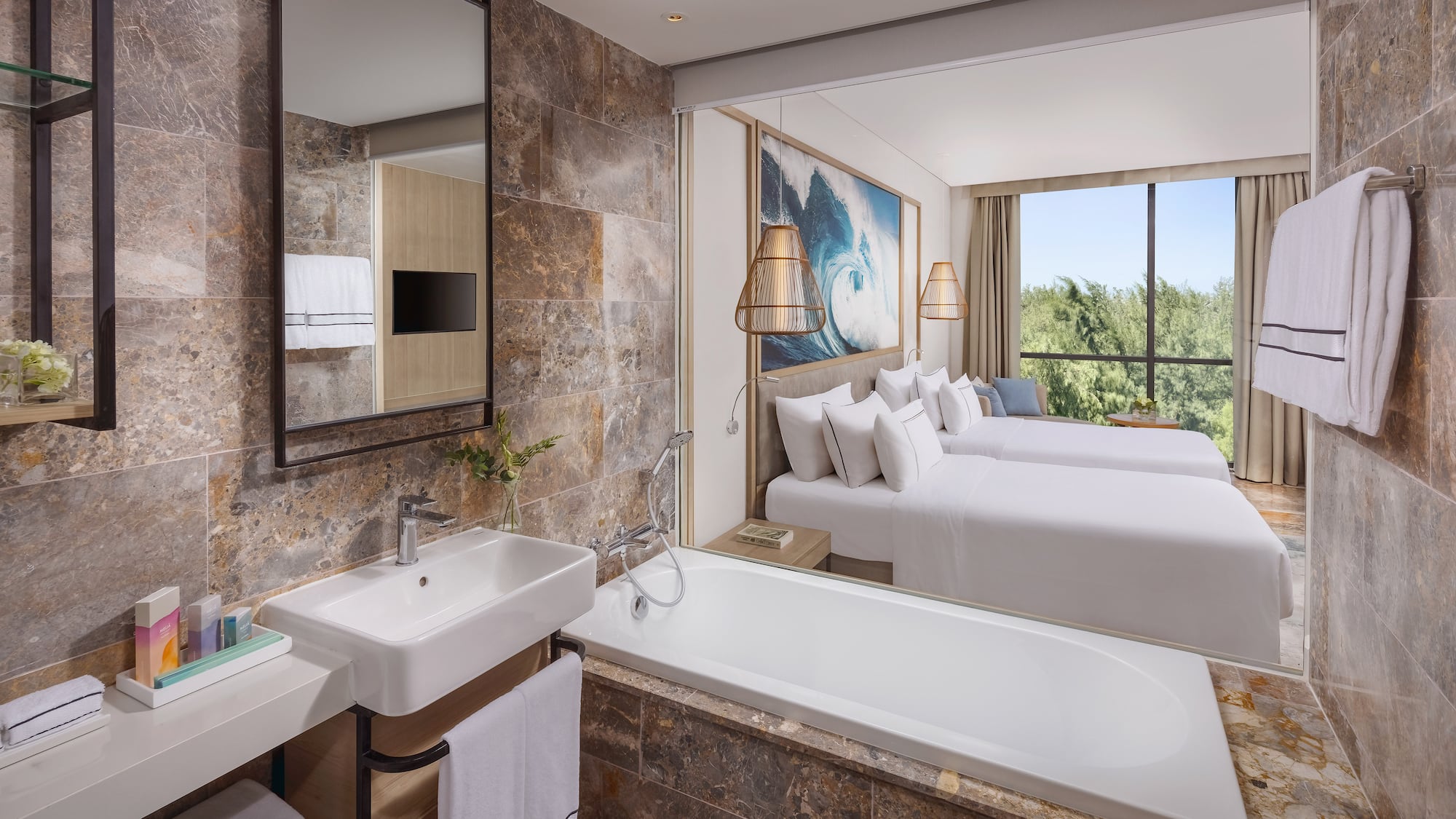 a bathroom with a bathtub and two beds