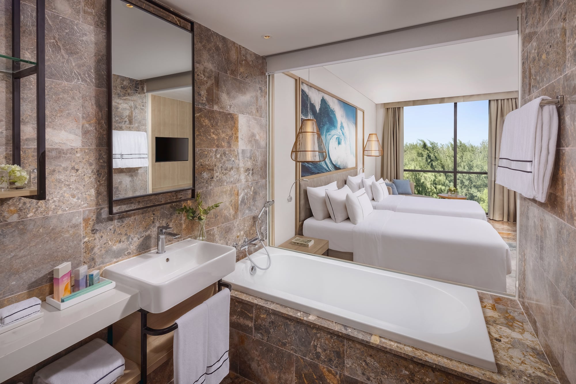 a bathroom with a bathtub and two beds