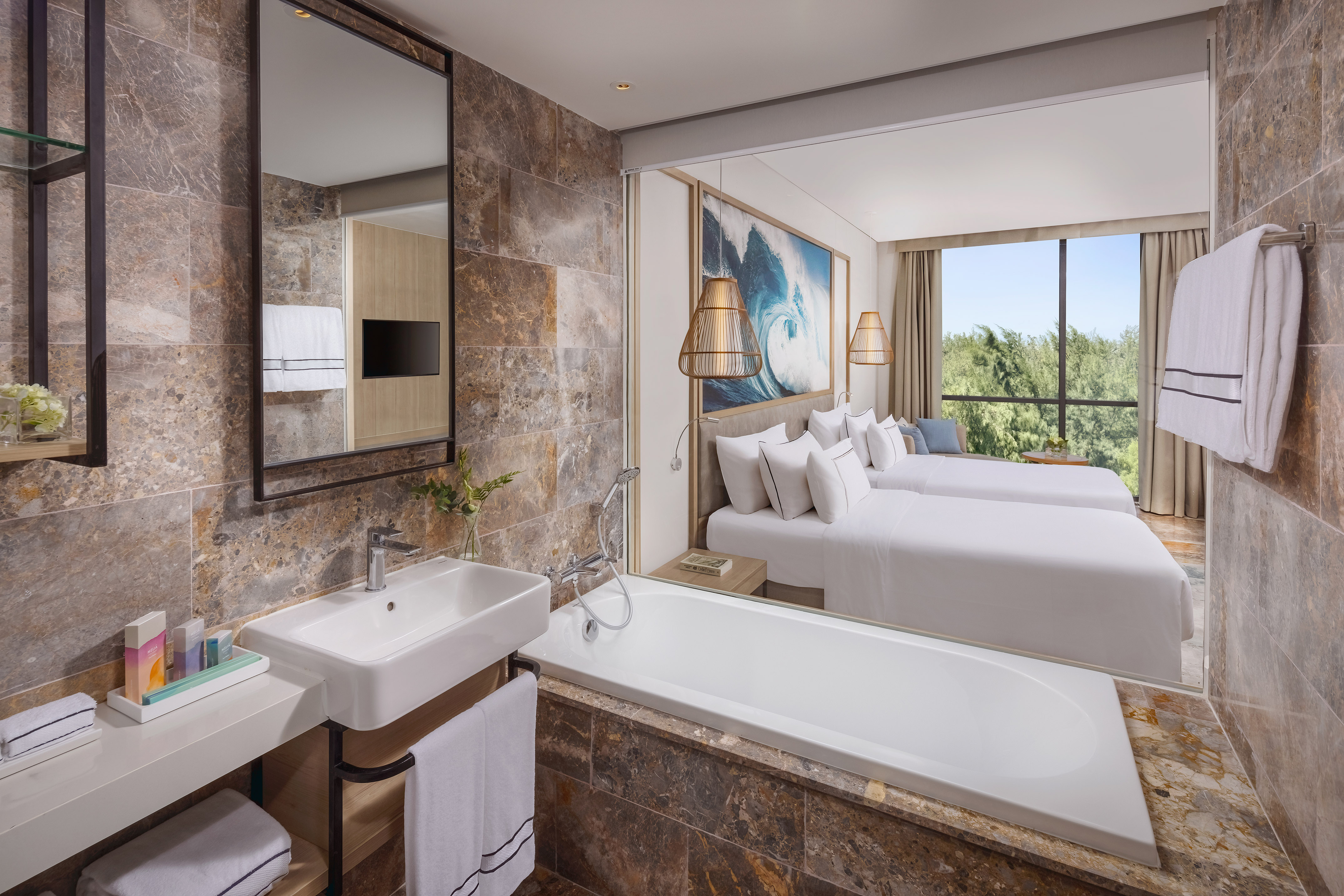 a bathroom with a bathtub and two beds