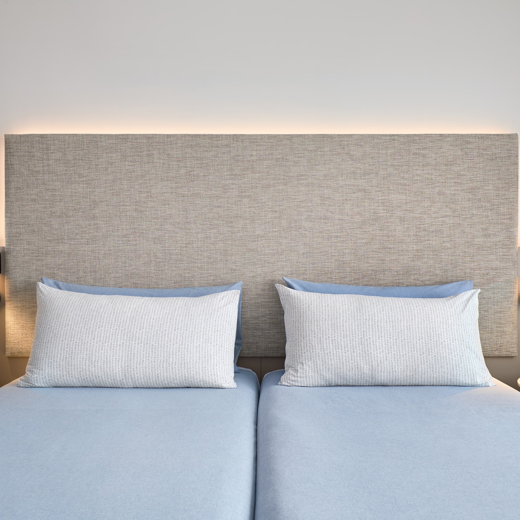 a bed with two pillows