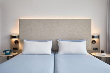a bed with two pillows