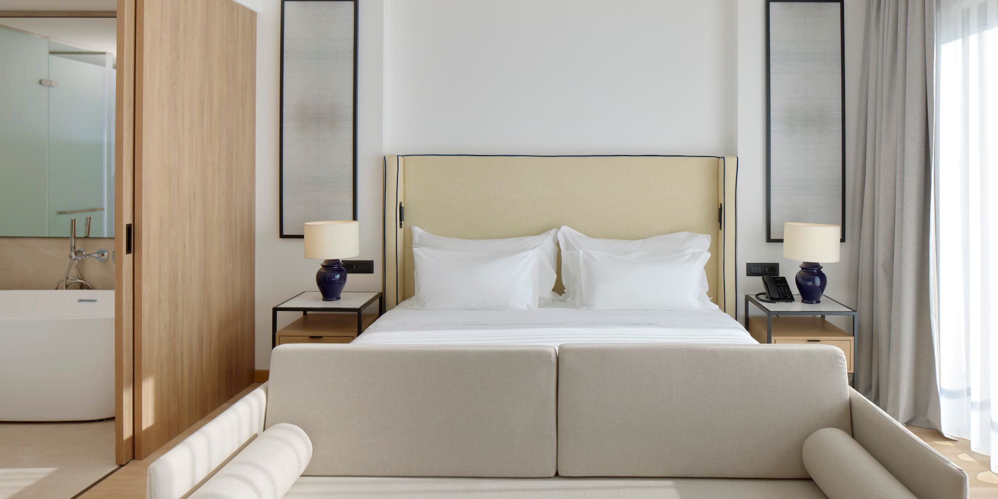 a bed with a couch and a lamp