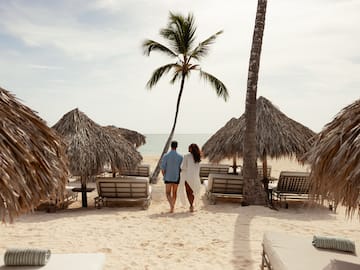 a man and woman walking on a beach