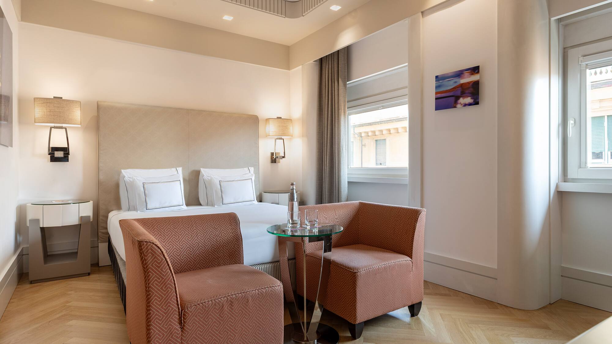 a room with a bed and chairs