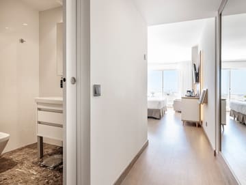 a hallway with a bed and a mirror