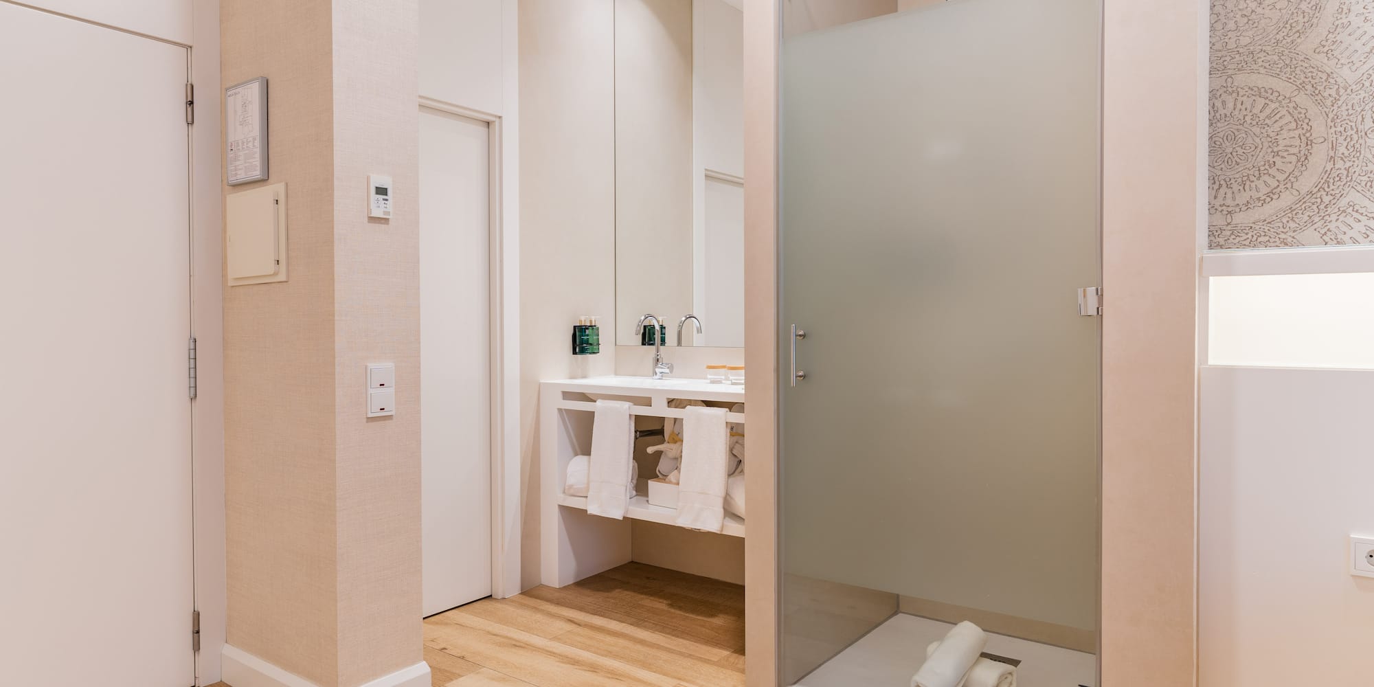 a bathroom with a glass shower door