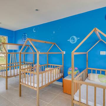 a room with cribs and blue walls