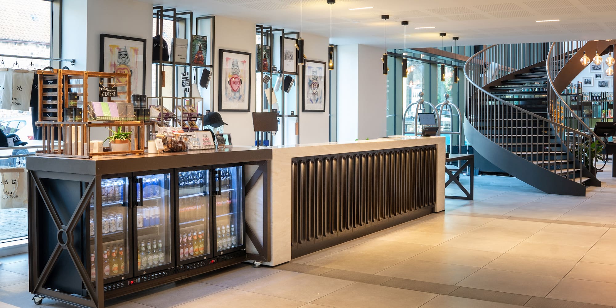 a room with a spiral staircase and a counter with drinks