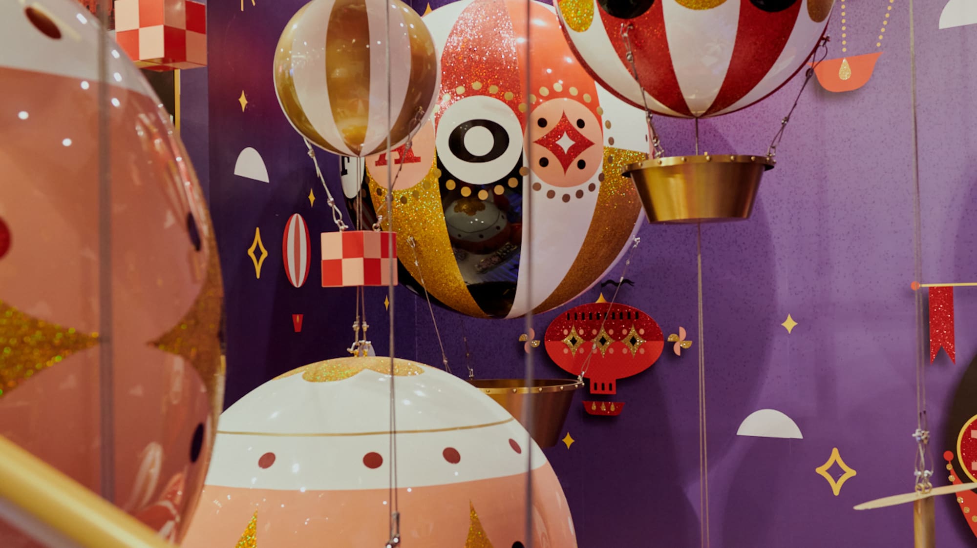 a group of colorful balloons from a ceiling