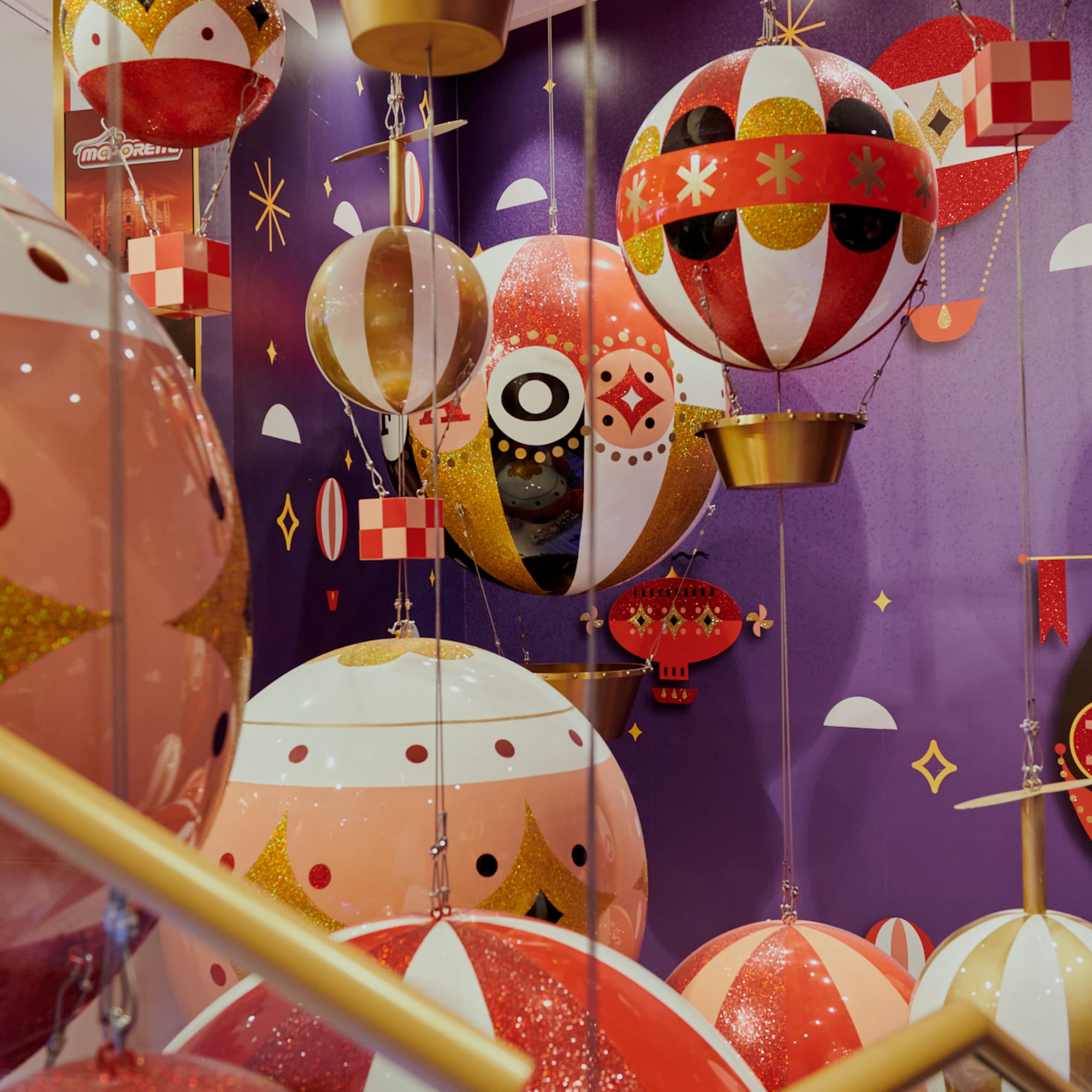 a group of colorful balloons from a ceiling