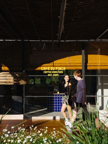 a man and woman walking in front of a glass building