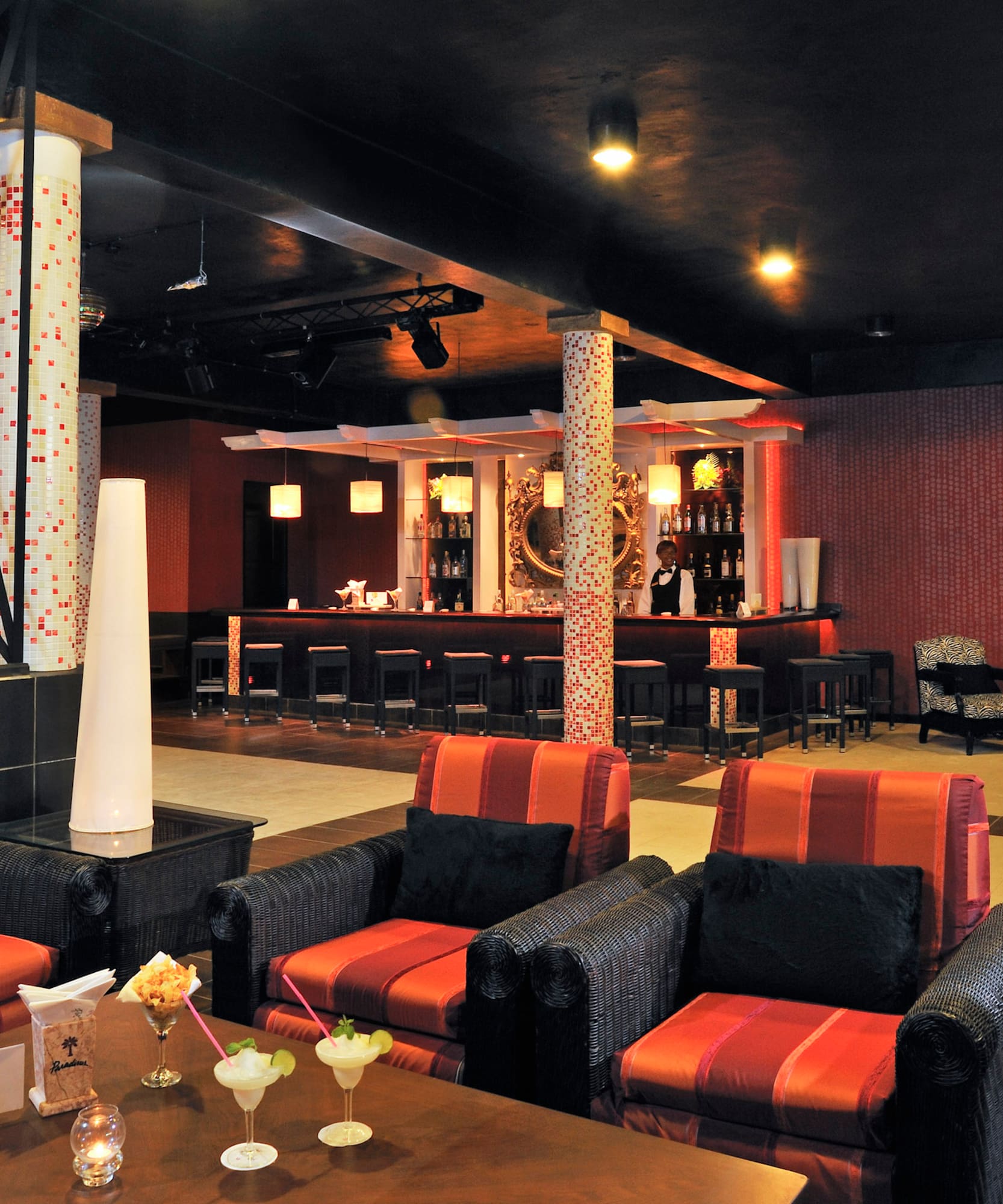 a room with red and black chairs and tables