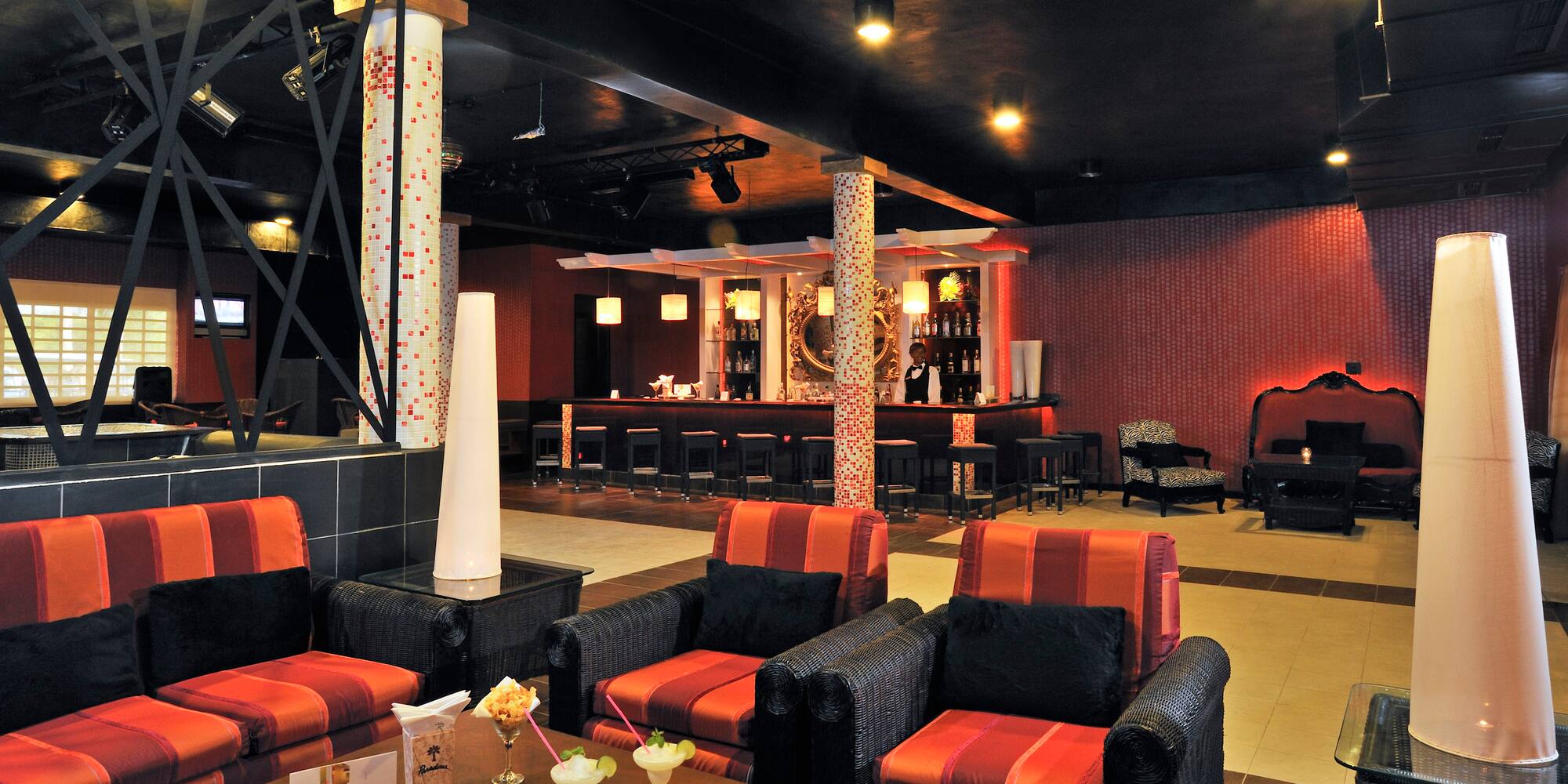 a room with red and black chairs and tables