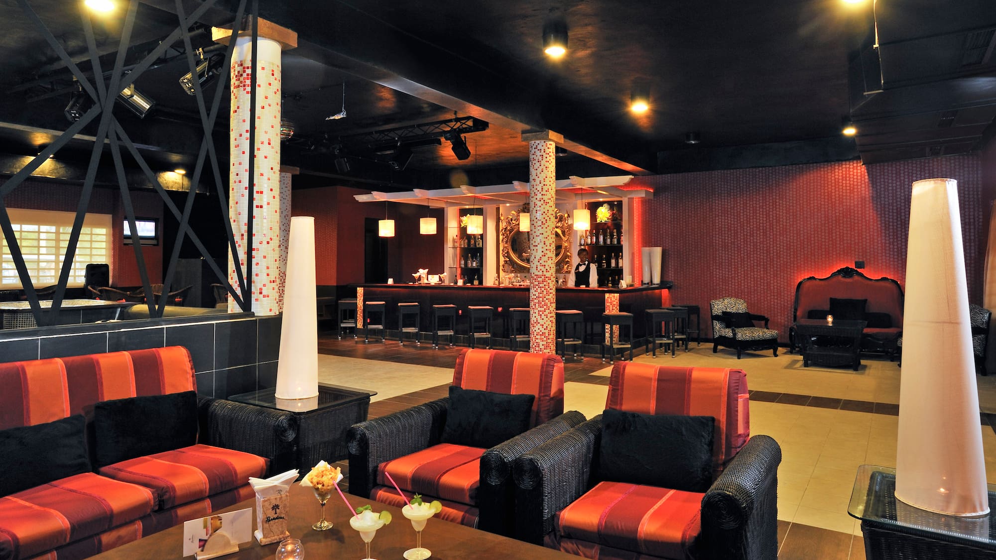 a room with red and black chairs and tables