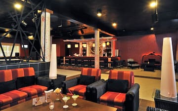 a room with red and black chairs and tables