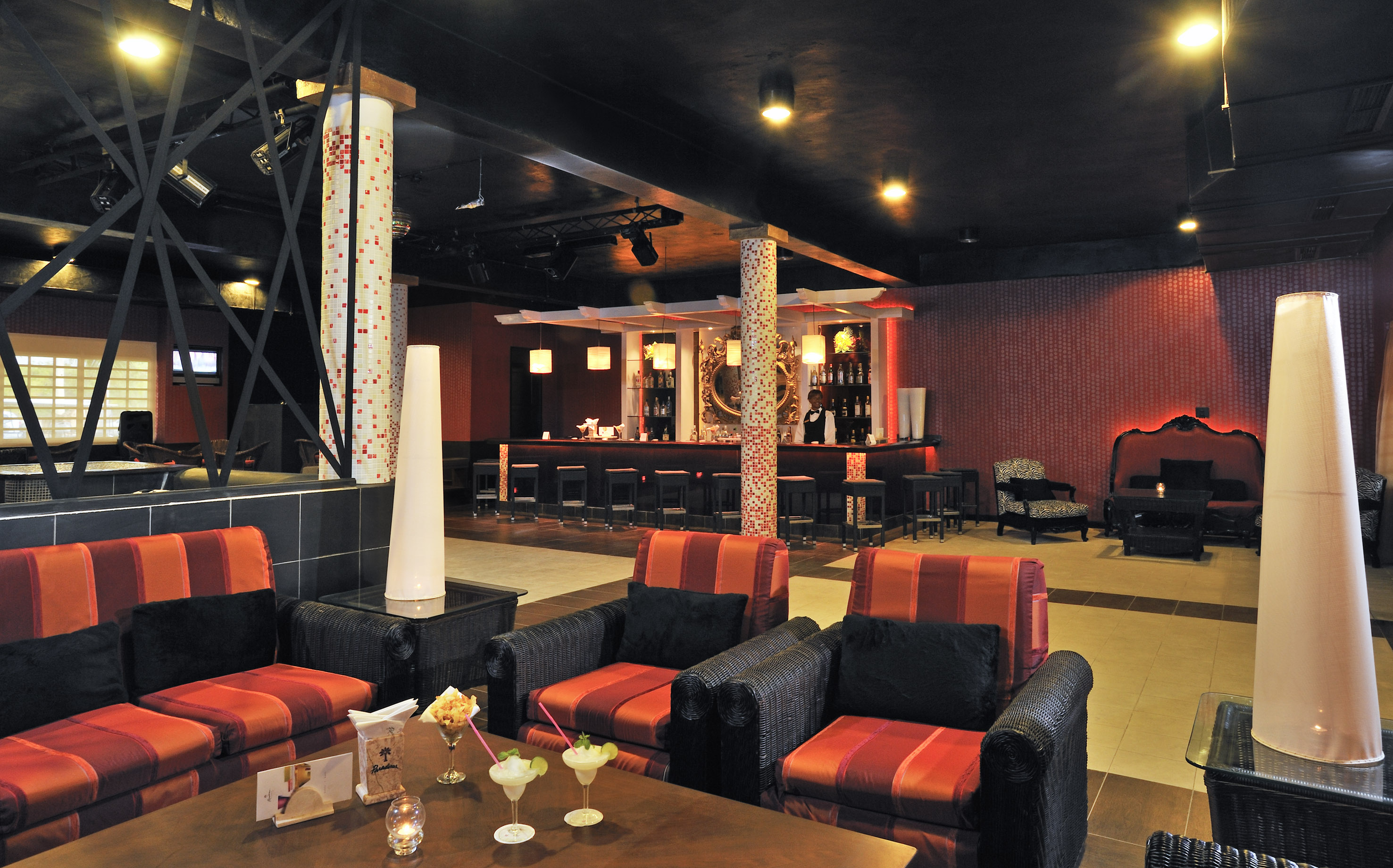 a room with red and black chairs and tables