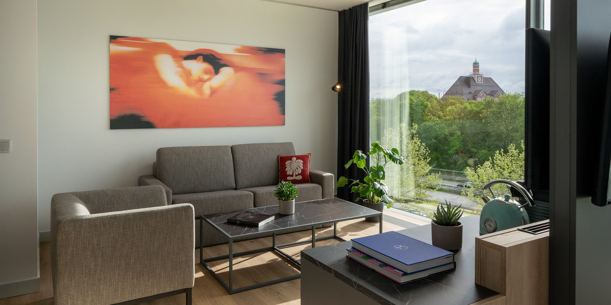 a living room with couches and a table and chairs